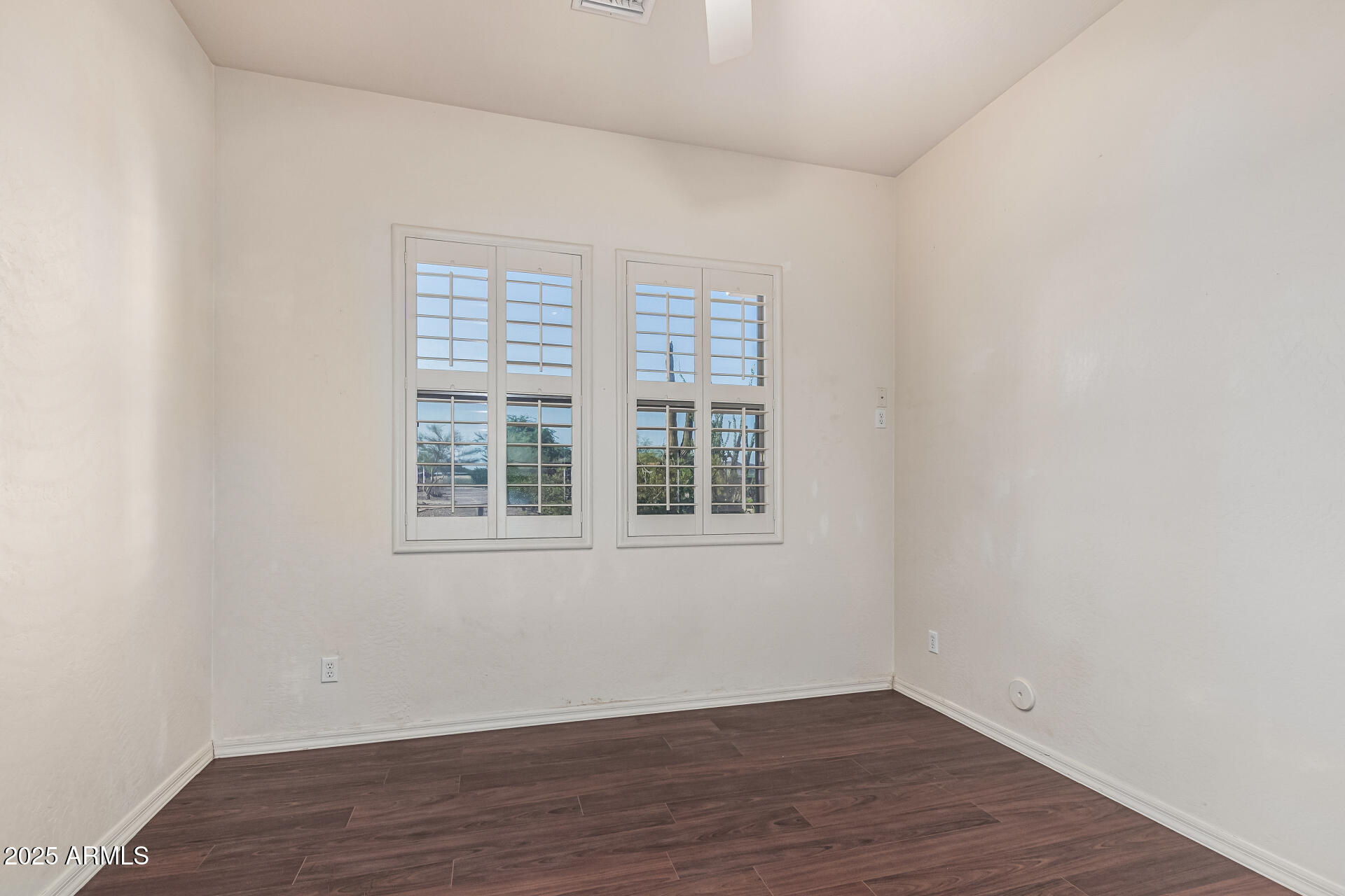 15639 West Peak View Road Surprise, AZ 85387 - Photo 67 of 131 an empty room with wooden floor and windows