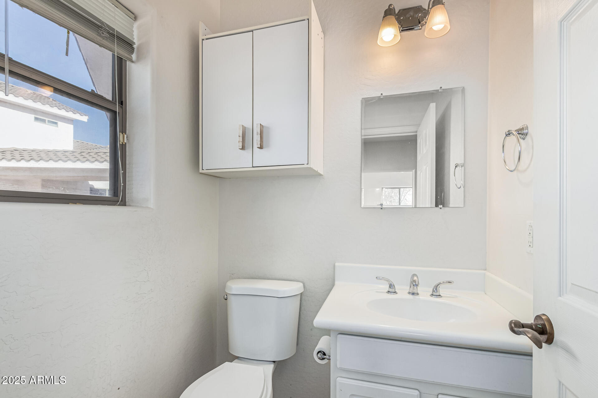 15639 West Peak View Road Surprise, AZ 85387 - Photo 83 of 131 a bathroom with a sink mirror and toilet