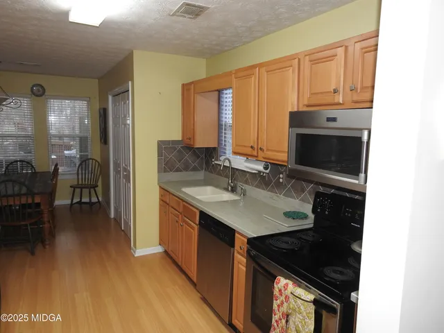 a kitchen with a sink stove and cabinets