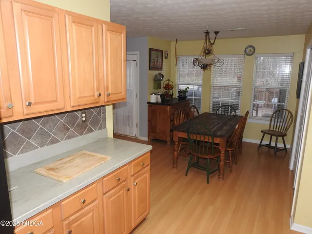 a kitchen with a wooden table and chairs