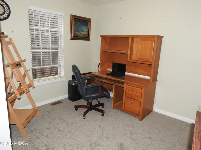 a view of workspace with furniture and windows