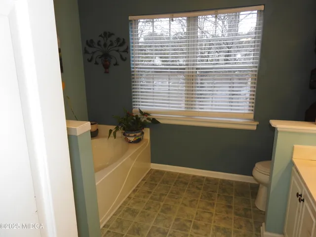 a bathroom with a sink a toilet and a shower