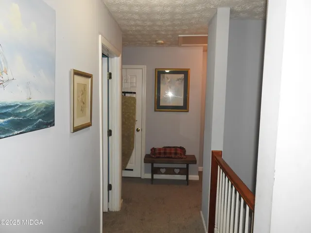 a view of a hallway with wooden floor and entryway