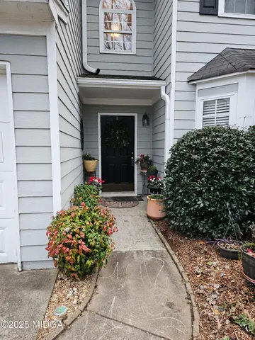 a view of a pathway with potted plants