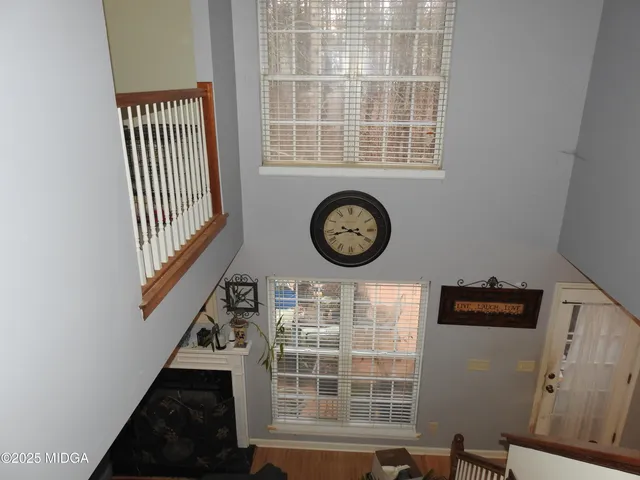 a view of a room with wooden floor and windows