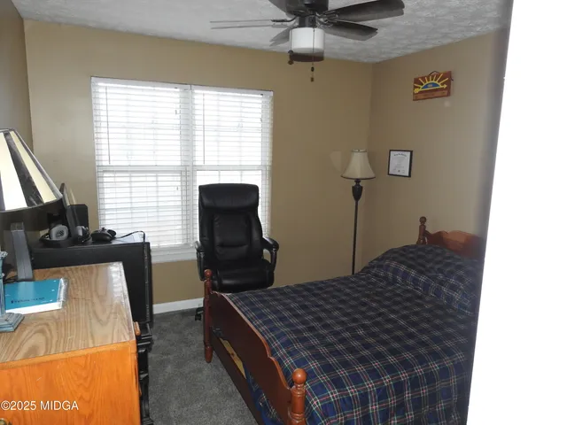 a bedroom with a bed and a table