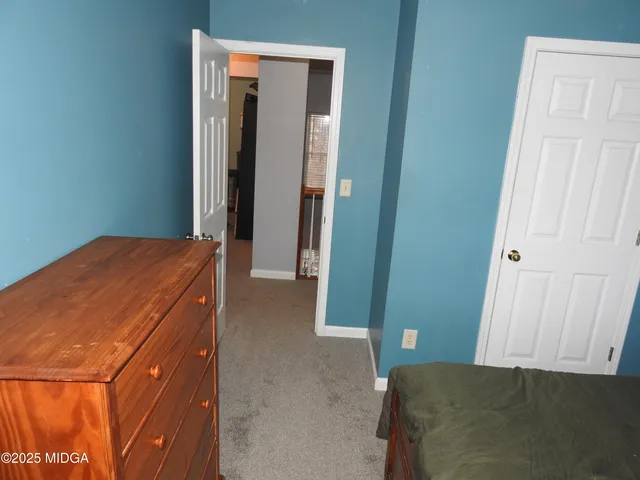 a bedroom with a bed and a mirror