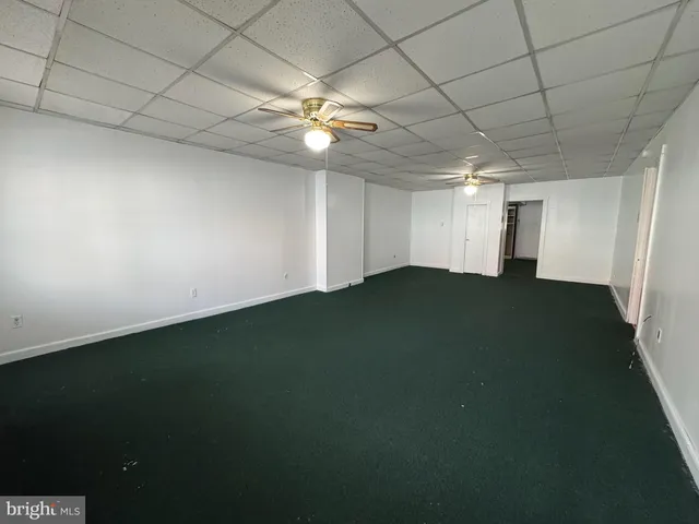 an empty room with a empty space and a ceiling fan