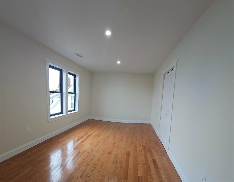 31 Niagara Street Fall River, MA 02721 - Photo 15 of 19 a view of an empty room with wooden floor and window