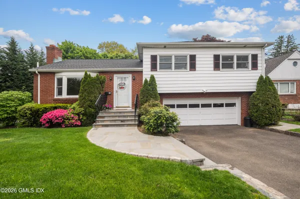 a front view of a house with a yard and garage