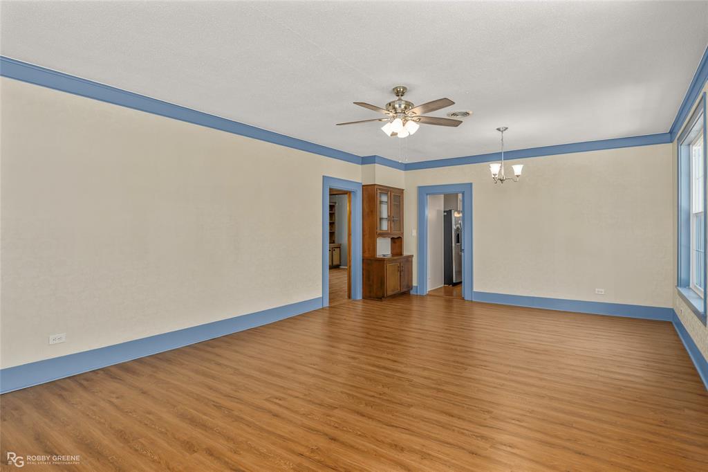 104 3rd Street Northwest Springhill, LA 71075 - Photo 5 of 28 a view of an empty room with wooden floor and a ceiling fan