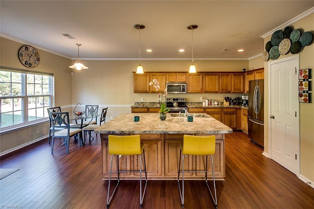 2169 Rindle Drive High Point, NC 27262 - Photo 13 of 30 Pendulum lights accent this perfect space for Wednesday night pizza or a Friday night social.
