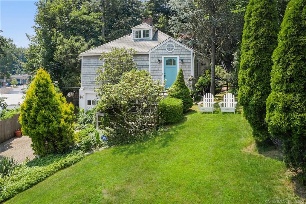 7 Cedar Road Westport, CT 06880 - Photo 1 of 1 a front view of a house with a yard and trees