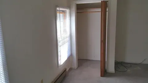 a view of an empty room and a window