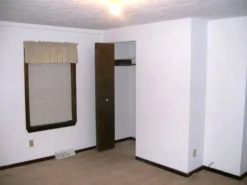 a view of an empty room with closet