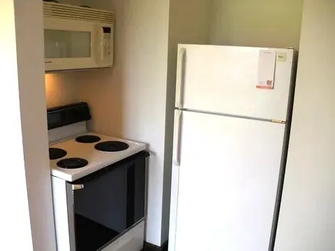 a white refrigerator freezer sitting inside of a kitchen