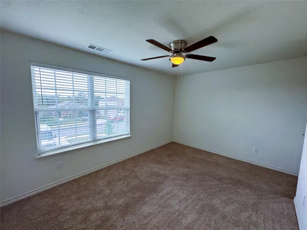 an empty room with a window and traffic signal