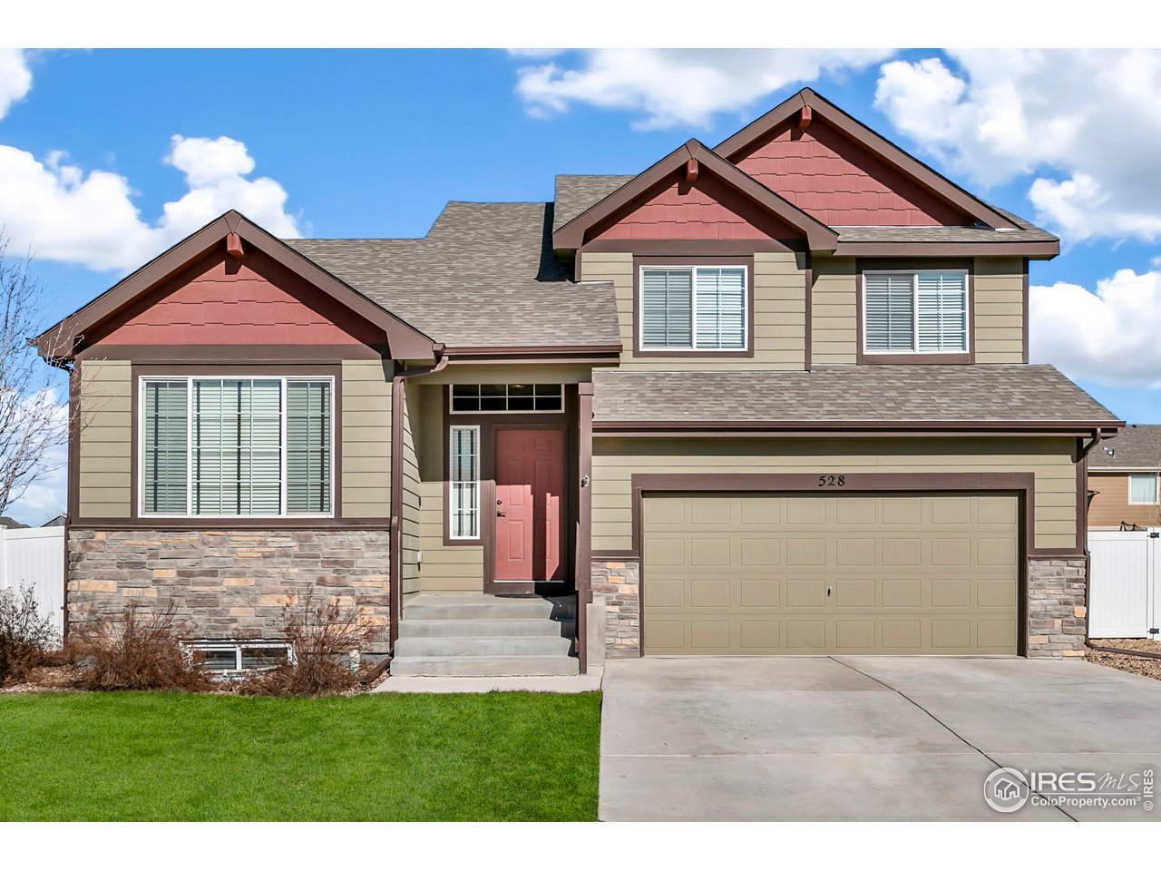 528 El Diente Avenue Severance, CO 80550 - Photo 1 of 19 a front view of a house with a yard and garage