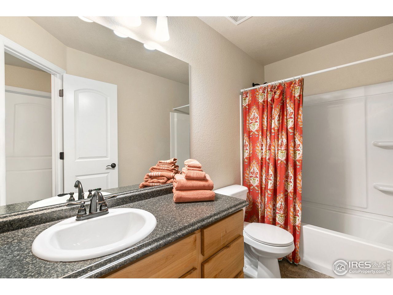 528 El Diente Avenue Severance, CO 80550 - Photo 15 of 19 a bathroom with a granite countertop sink mirror vanity and toilet