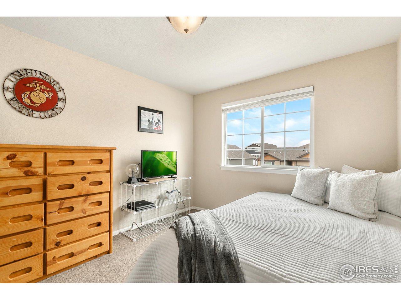 528 El Diente Avenue Severance, CO 80550 - Photo 16 of 19 a bedroom with a bed and a window