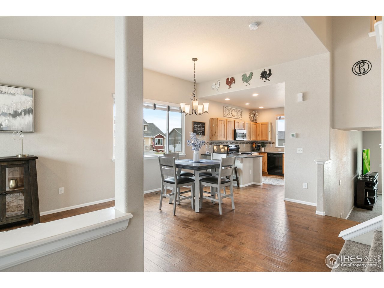 528 El Diente Avenue Severance, CO 80550 - Photo 5 of 19 a dining room with furniture and wooden floor