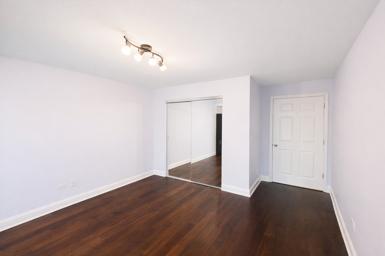 1575 Sandpebble Drive, Unit 104 Wheeling, IL 60090 - Photo 6 of 8 a view of a room with wooden floor and white walls