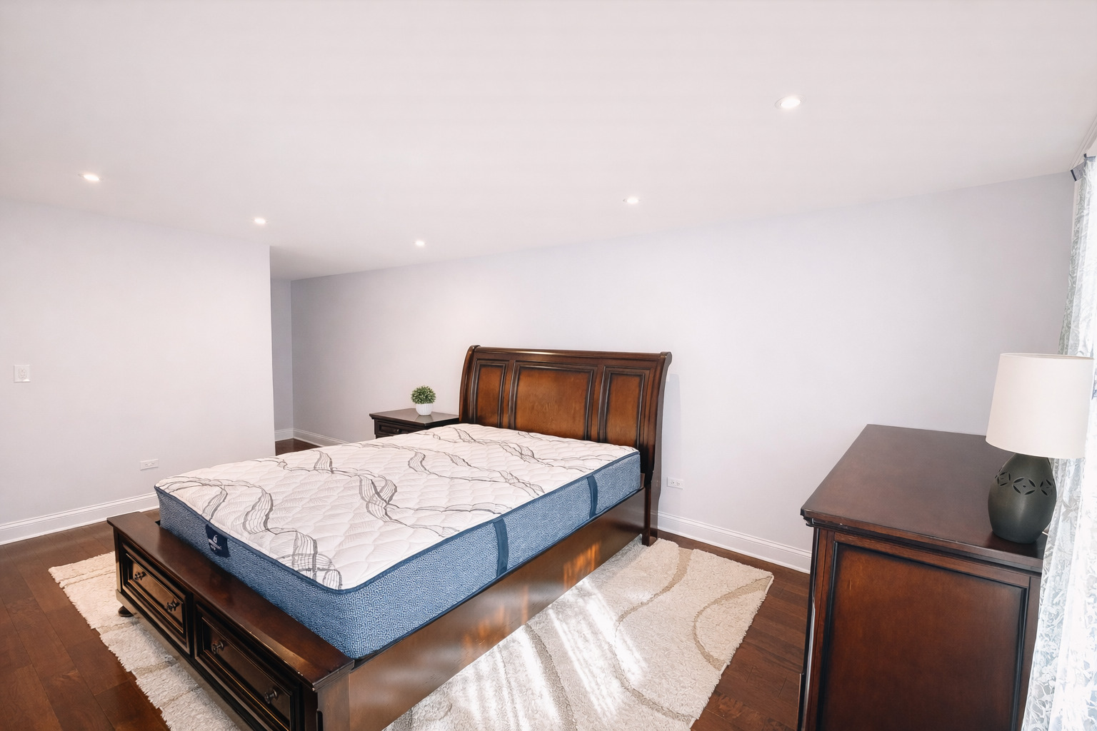 1575 Sandpebble Drive, Unit 104 Wheeling, IL 60090 - Photo 8 of 8 a bedroom with a bed and wooden floor
