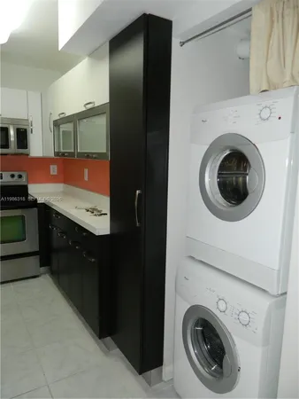 a spacious bathroom with a sink a washer and dryer
