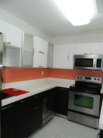 a kitchen with stainless steel appliances a stove cabinets and a microwave