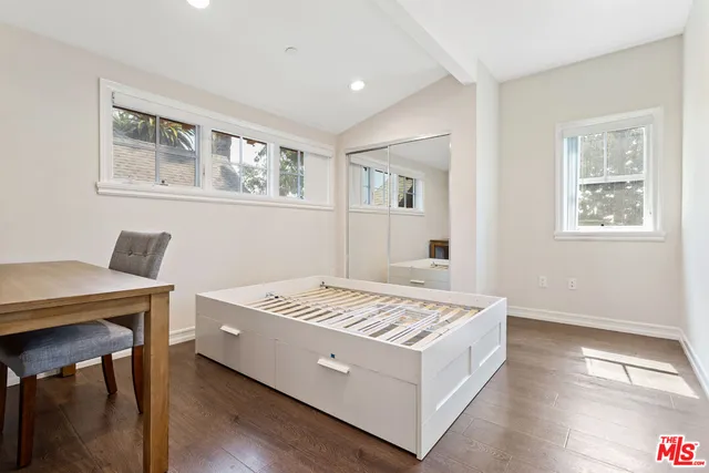 a living room with a bed and a table