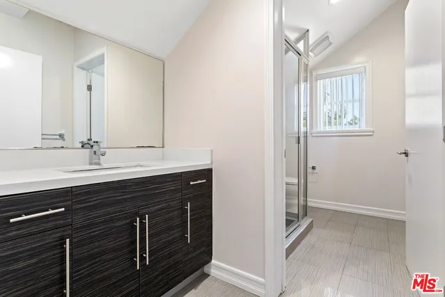 a bathroom with a sink a mirror and a window