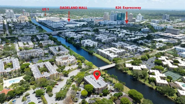 an aerial view of residential houses with outdoor space and swimming pool