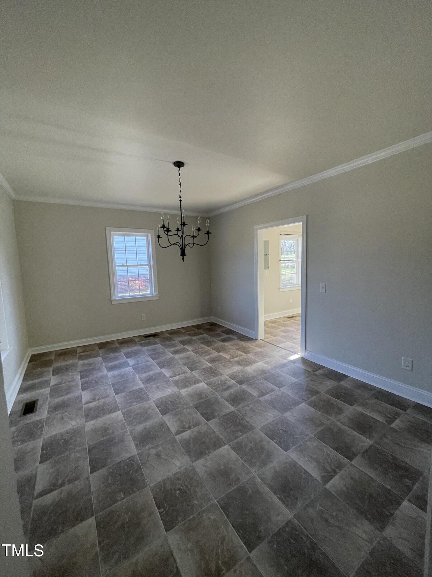 119 Academy Street Roxboro, NC 27573 - Photo 11 of 22 a view of an empty room and window