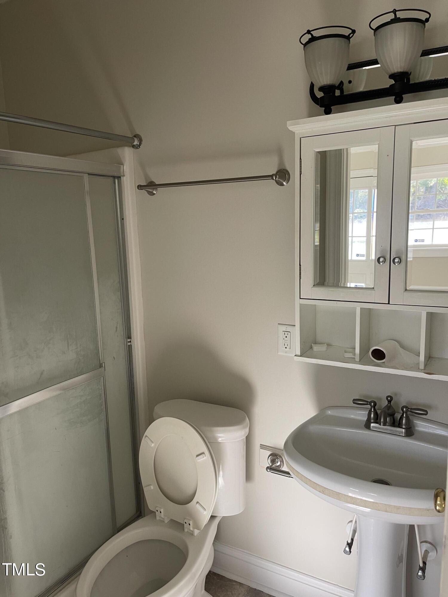119 Academy Street Roxboro, NC 27573 - Photo 15 of 22 a bathroom with a toilet and a sink