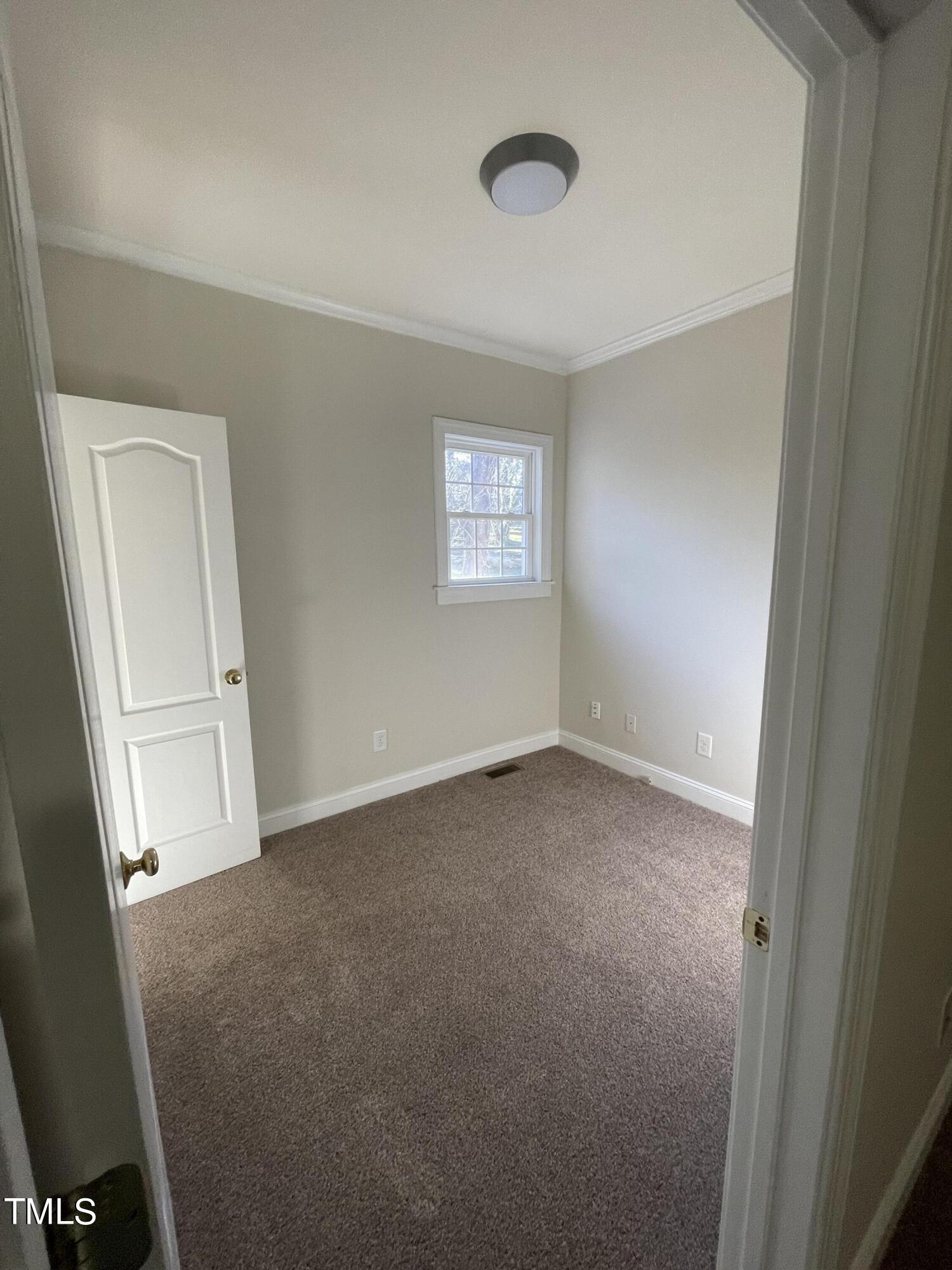 119 Academy Street Roxboro, NC 27573 - Photo 16 of 22 an empty room with windows