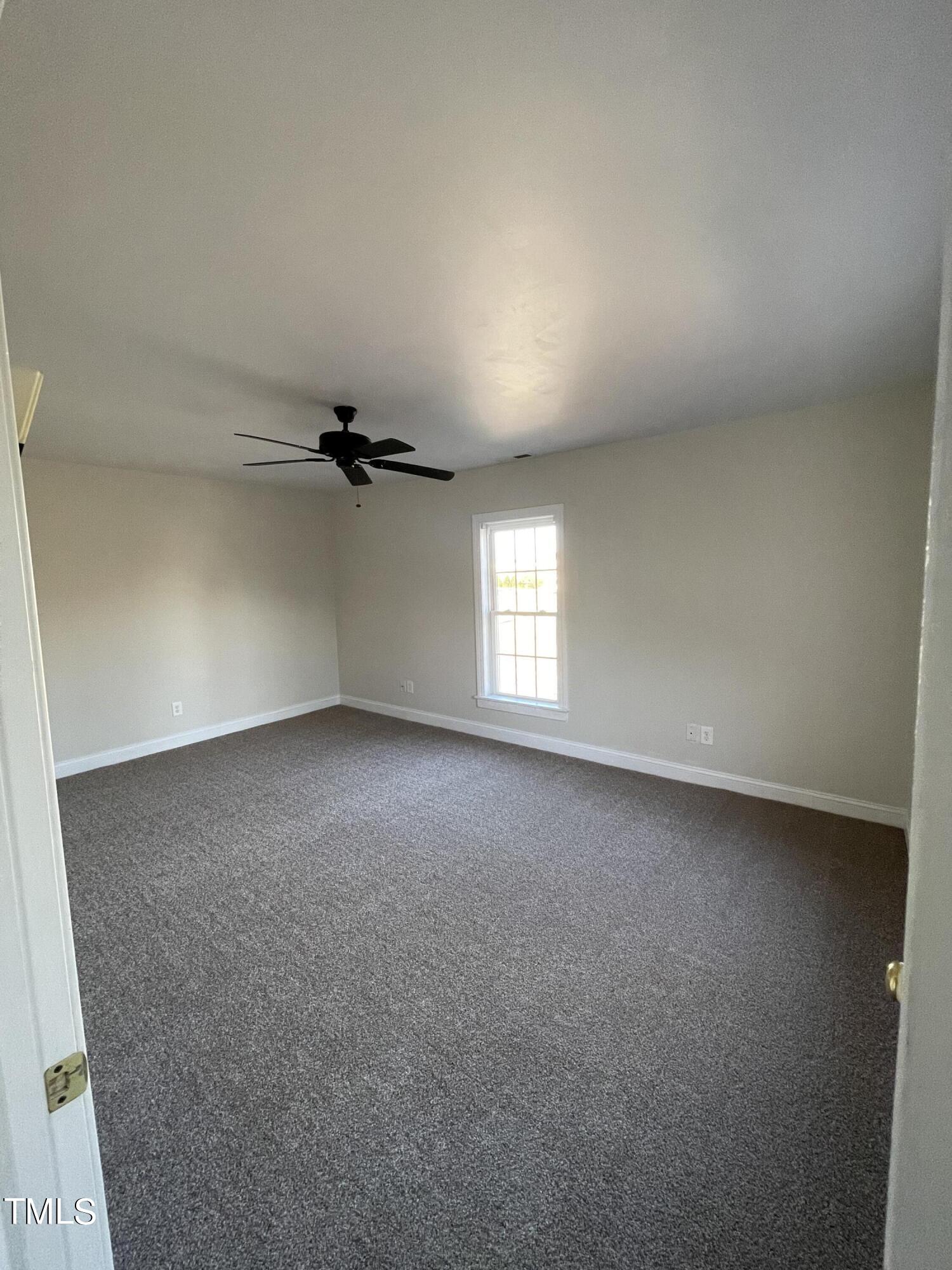 119 Academy Street Roxboro, NC 27573 - Photo 18 of 22 an empty room with windows and fan
