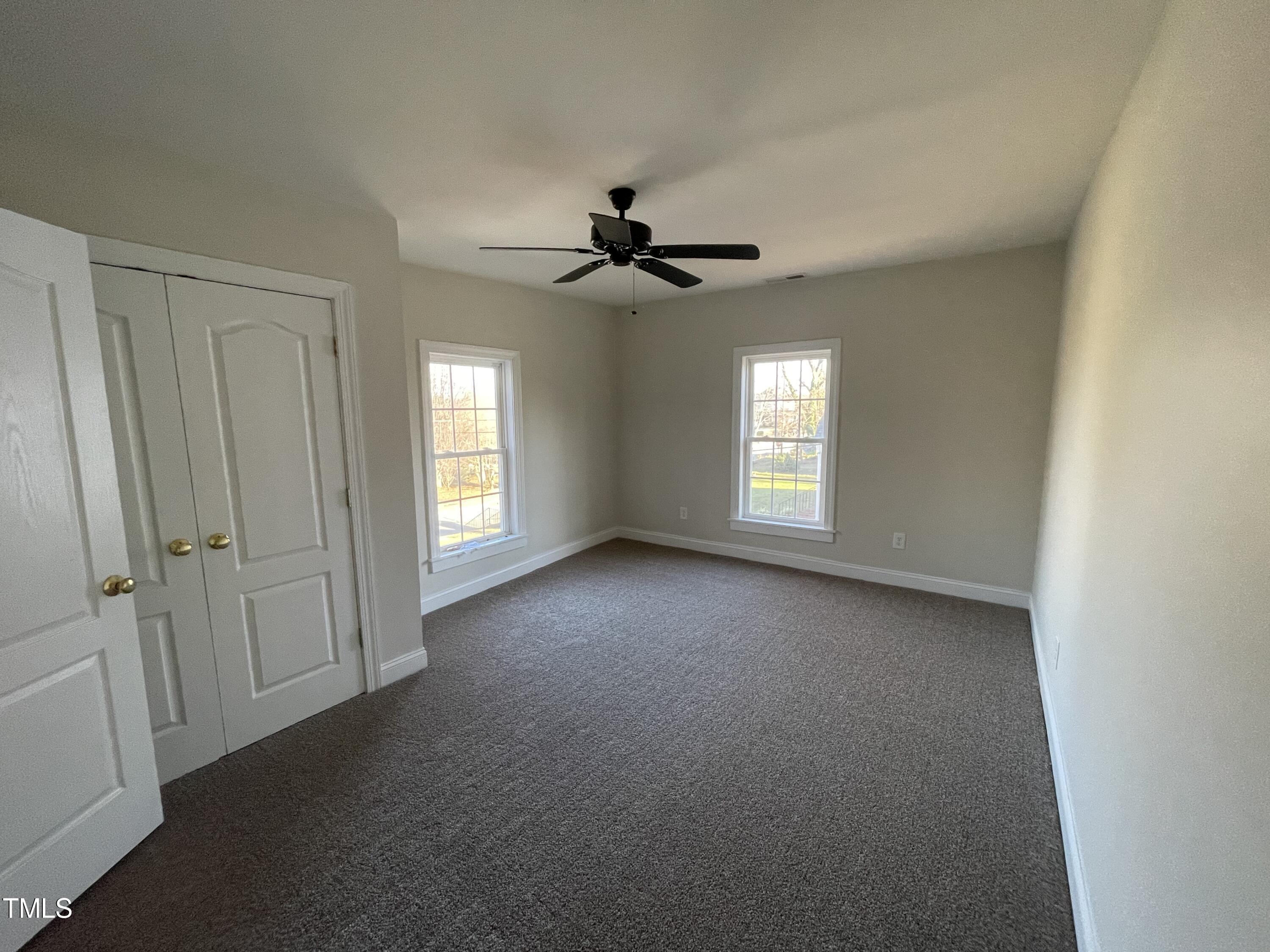 119 Academy Street Roxboro, NC 27573 - Photo 20 of 22 wooden floor in an empty room with a window