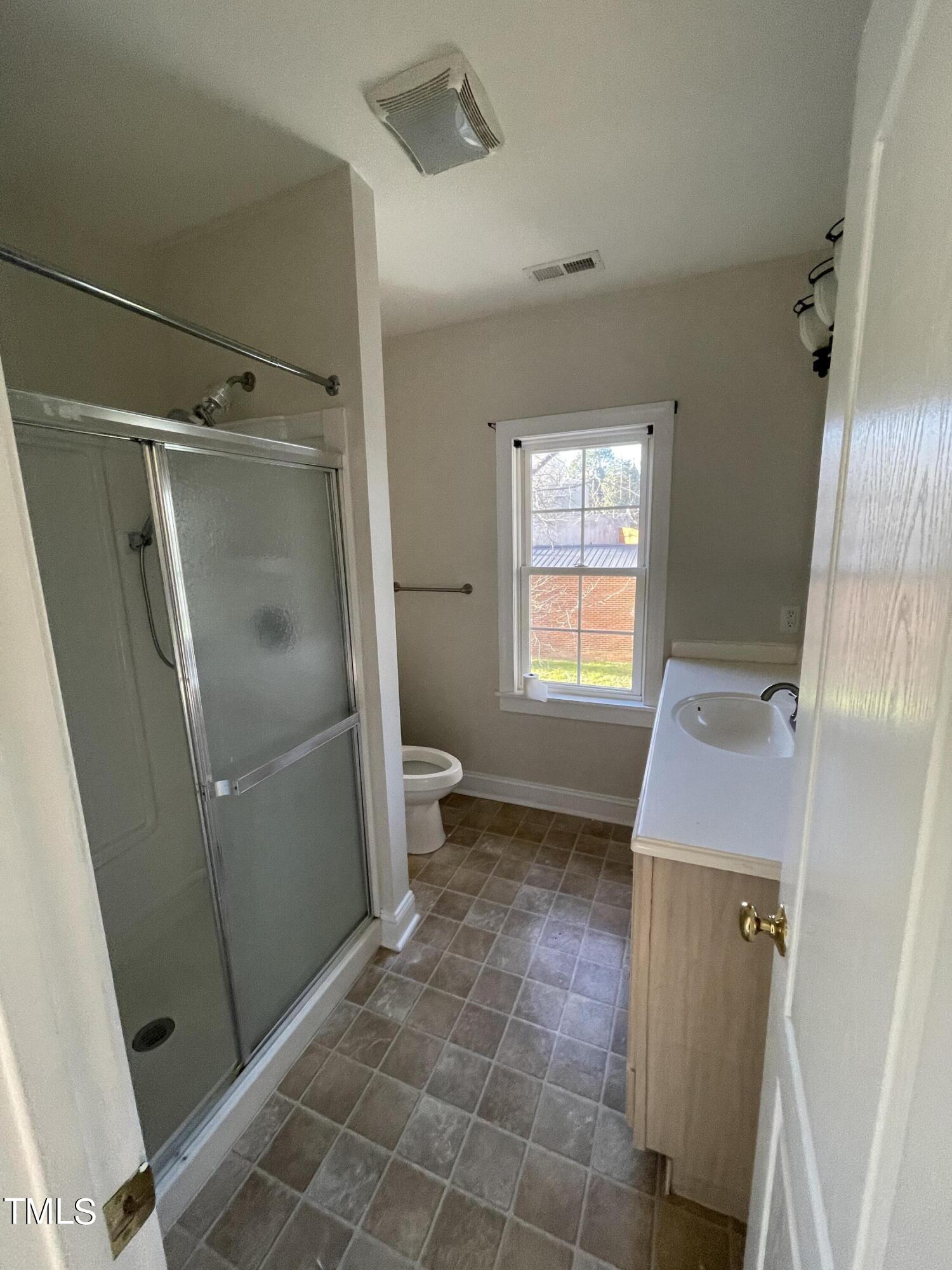 119 Academy Street Roxboro, NC 27573 - Photo 22 of 22 a bathroom with a sink a toilet and a shower