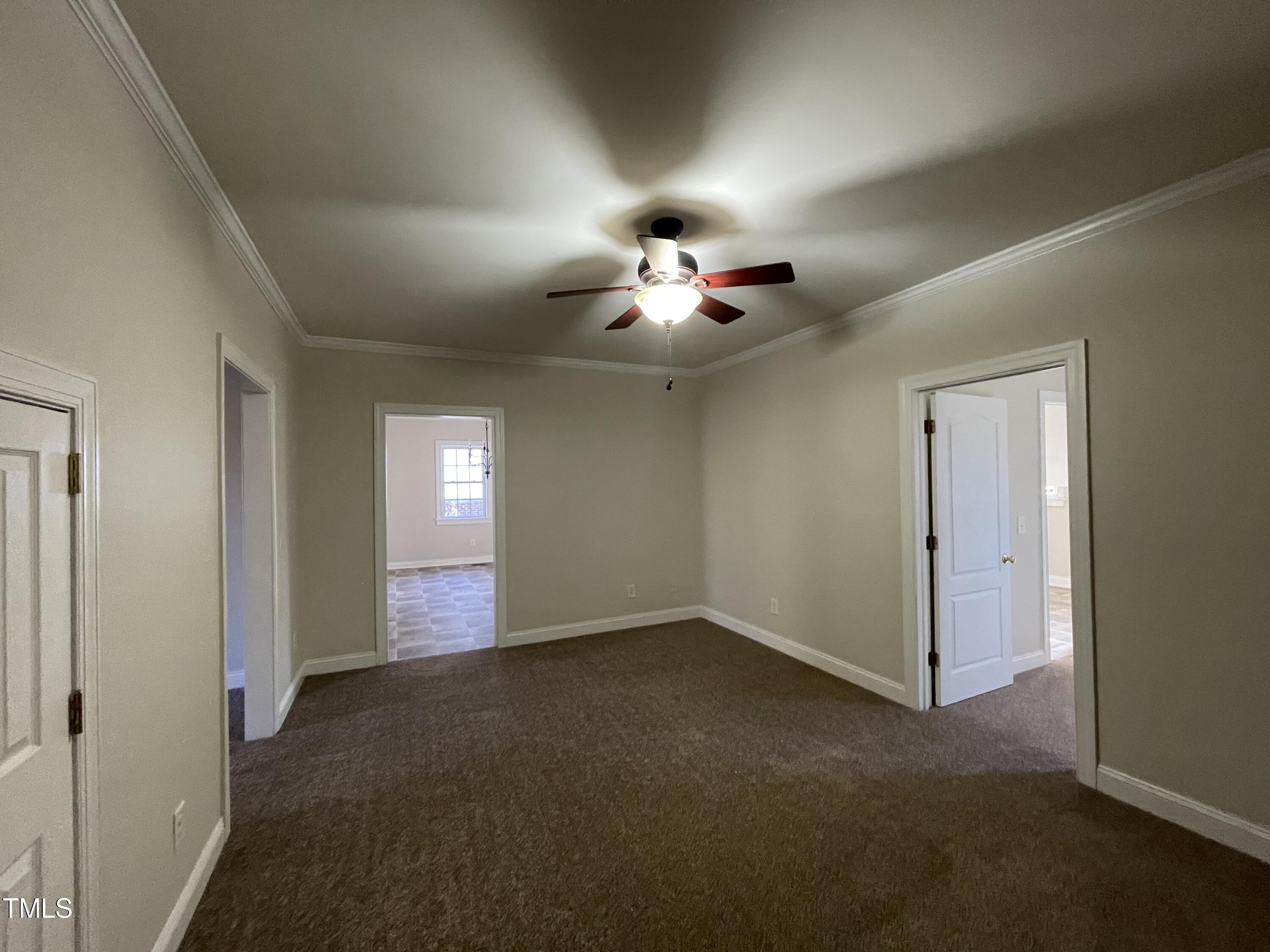 119 Academy Street Roxboro, NC 27573 - Photo 10 of 22 a view of an empty room with a chandelier fan