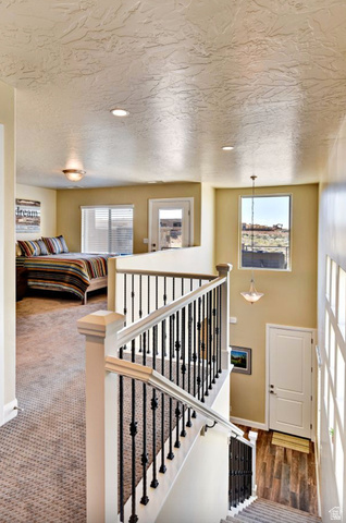 1622 Canyon Tree Drive St. George, UT 84770 - Photo 24 of 34 Staircase featuring white newel posts and handrails with black decorative metal balusters