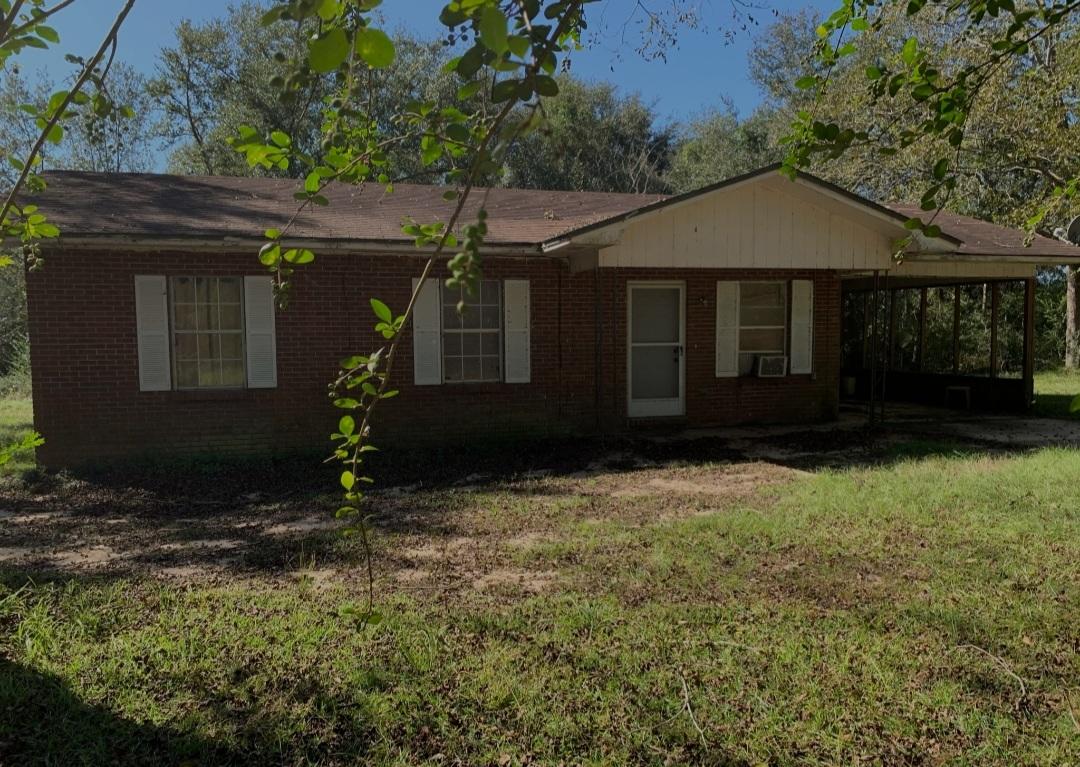1470 Reddick Mill Road Graceville, FL 32440 - Photo 1 of 11 a front view of a house with garden
