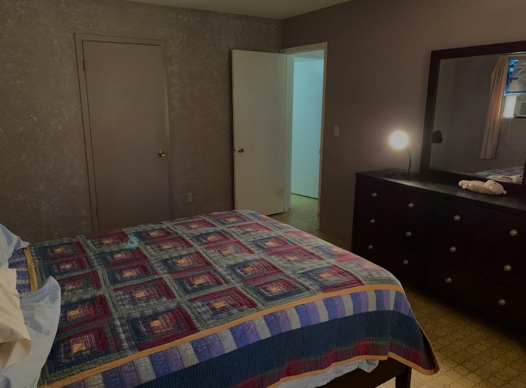 1470 Reddick Mill Road Graceville, FL 32440 - Photo 6 of 11 a bedroom with a bed and a dresser