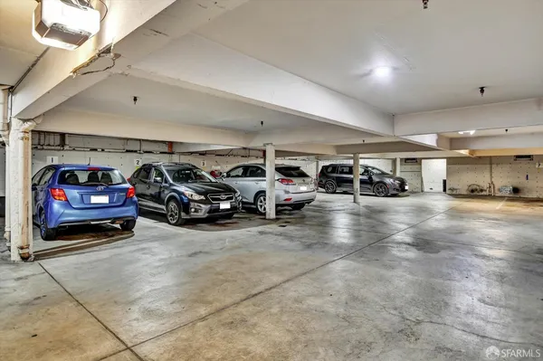 a view of parking garage with cars