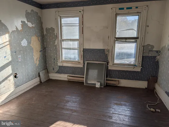 a view of room with a window and wooden floor