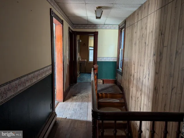 a view of a hallway and a livingroom with furniture