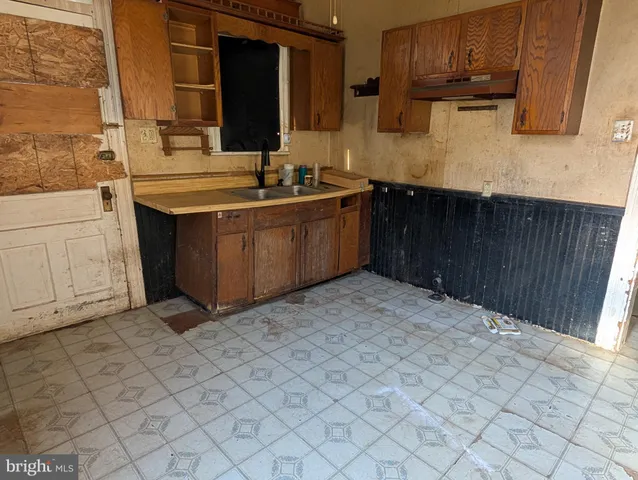 a kitchen with a sink and cabinets