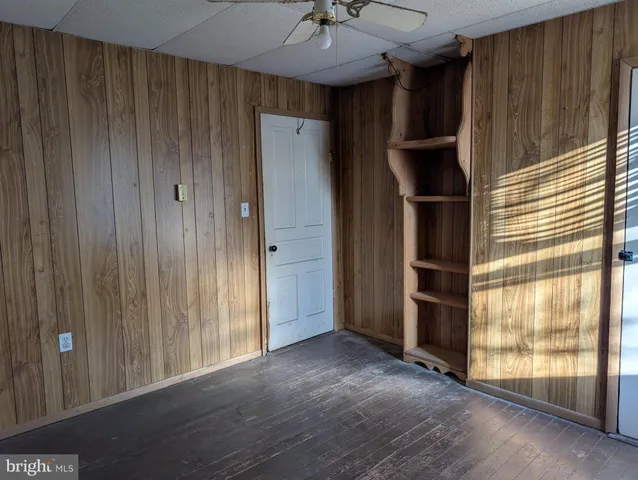 a view of a hallway with wooden shelves