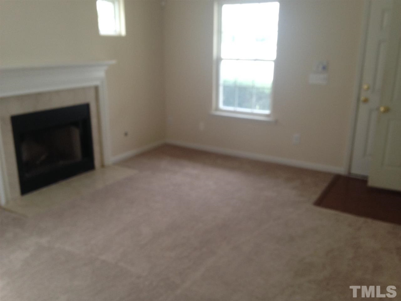 3232 Marcony Way Raleigh, NC 27610 - Photo 4 of 4 an empty room with a fireplace