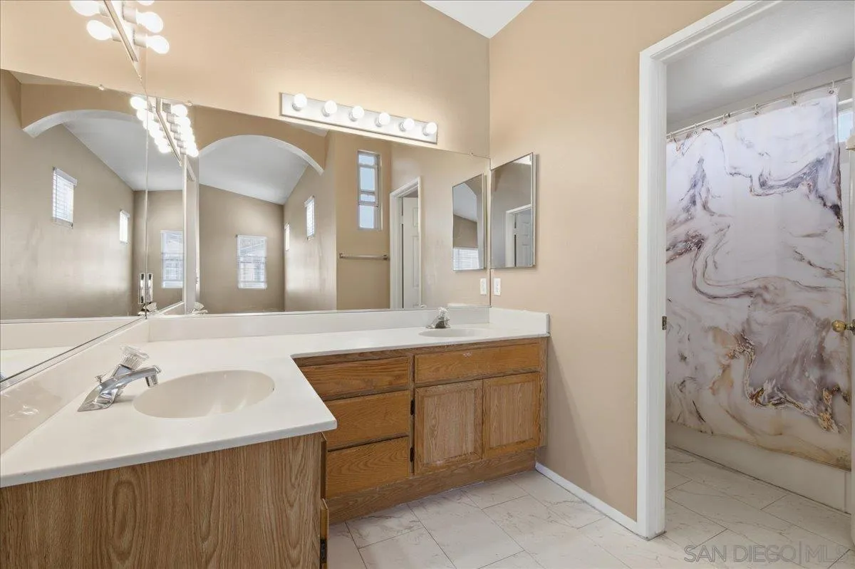 3143 Lamar Court Spring Valley, CA 91977 - Photo 17 of 40 a bathroom with a sink and a mirror
