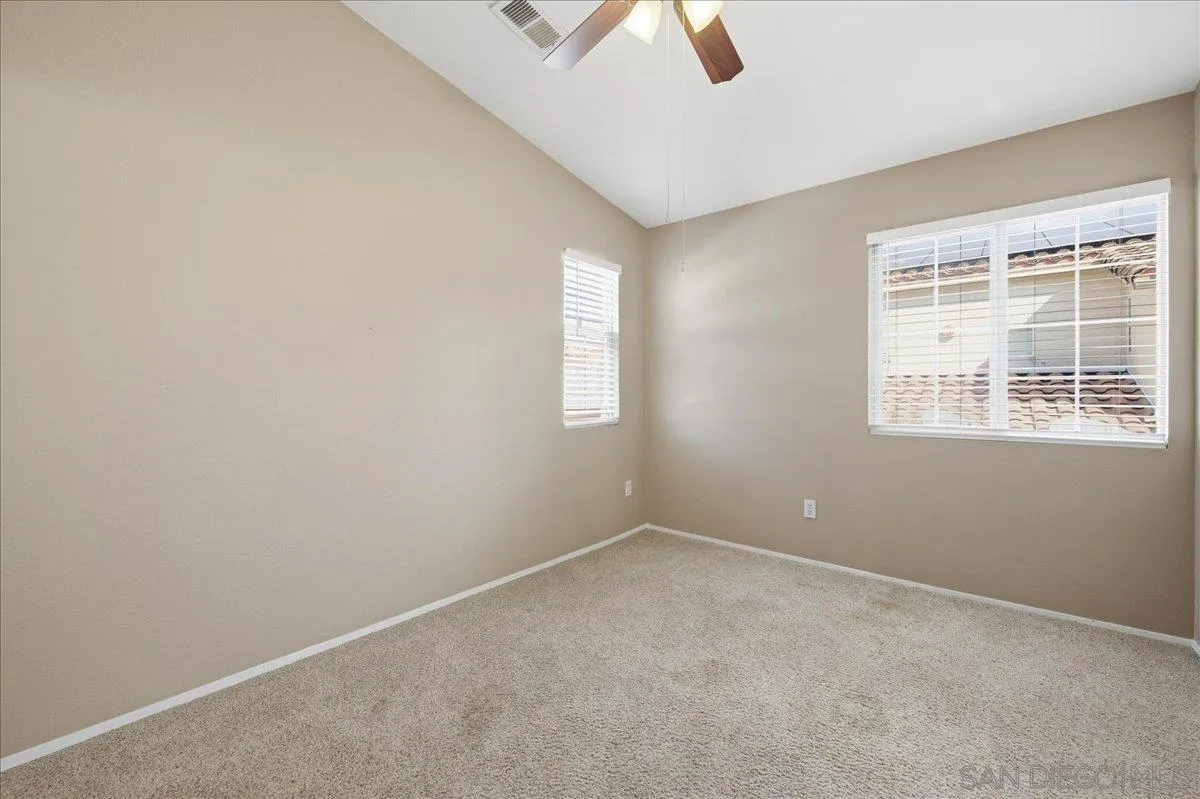 3143 Lamar Court Spring Valley, CA 91977 - Photo 20 of 40 an empty room with ceiling fan and window